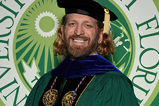 Dr. Ditrui in front of USF Seal