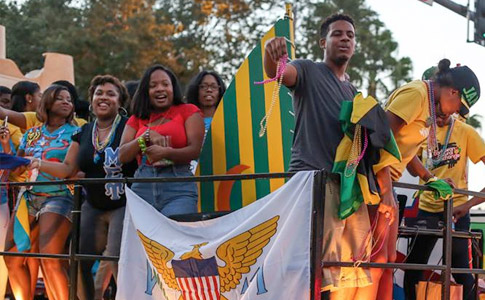 Students toss beads from a float during the 2014 Parade