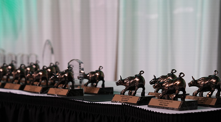 awards table with golden bull award statues on it