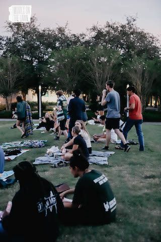 Students watching movies on the lawn
