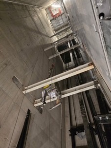Looking up from the bottom of the empty elevator shaft for car 1.
