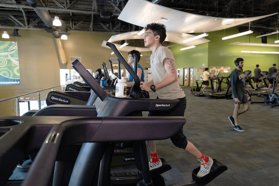 Student running on a treadmill at the Recreation Tampa location