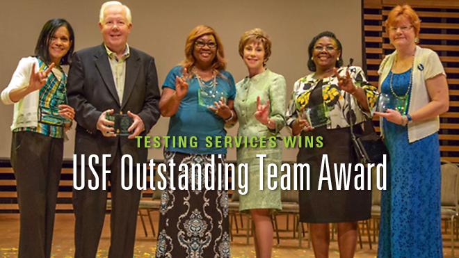 A group of woman and a man at the USF Outstanding Team Award with President Genshaft.