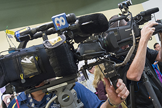 Local news cameras at USF event.