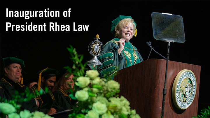 Rhea Law standing behind a podium with the USF seal with text reading "Inauguration of President Rhea Law".