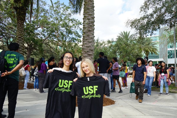 two female students with branded shirts