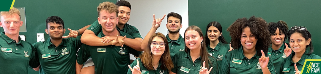 student mentors in green polos smiling