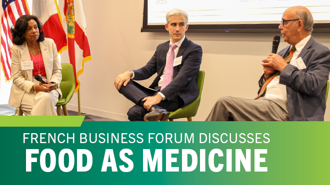 Three people talking in front with microphones