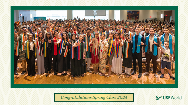 Large group photo of students with sashes representing their countries and holding up the "bulls" hand. The text "Congratulations Spring Class 2025" is under the photo.