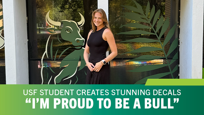 USF student smiles in front of bull decal on window