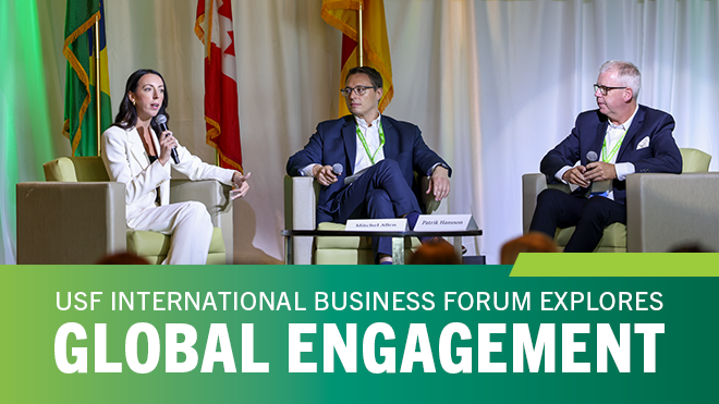 Group of people discussing in chairs before a crowd of people