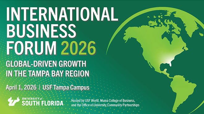 Person in red dress dances with leg in air at front of a group of dancers holding up picture frames