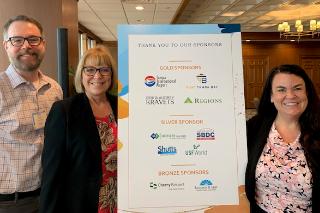 Rene, Amanda, and Wendy from USF World pose for a picture following Amanda receiving the 2023 TBOWIT Person of the Year award