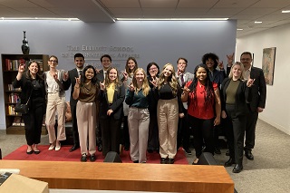 group of USF students dressed in business attire and standing inside of a building in Washington, D.C.