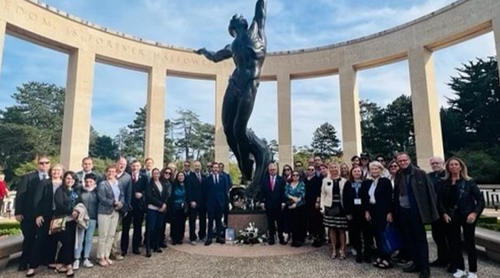 Tampa and Le Havre delgation posing for a photo after participating in a wreath-laying ceremony at the World War II American Cemetery near Omaha Beach in France.