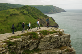 students hiking out on cliff face facing the English Channel