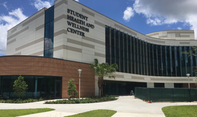 image of the front of the tan brick and white student health services building at the USF Tampa campus