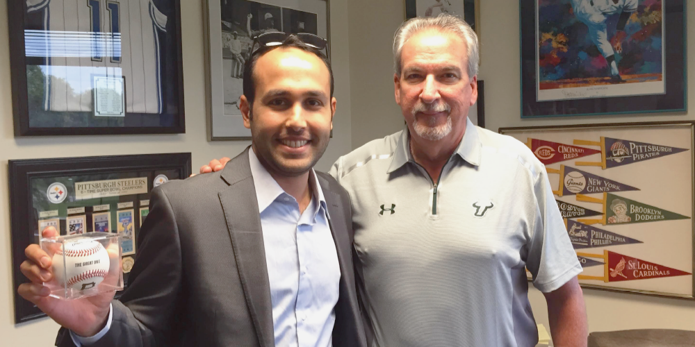 Abdullah Alabdullah holding a baseball and usf representative