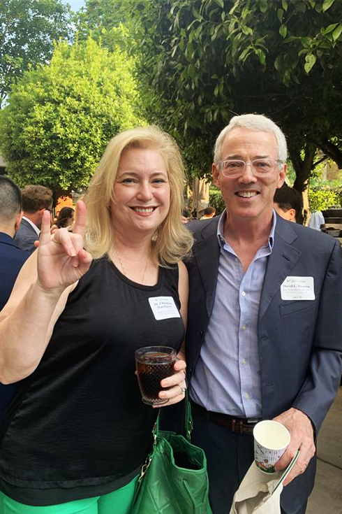 Two USF alumni smiling at camera.