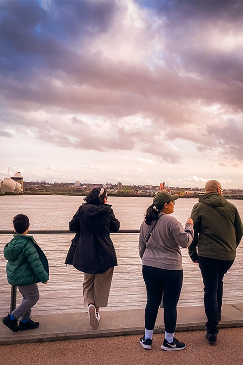 collazo family looking out over river during sunset
