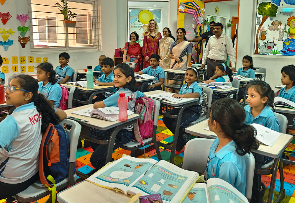representatives from USF World, NextGen International School, and the Founder of the institution observing a classroom of pupils in India