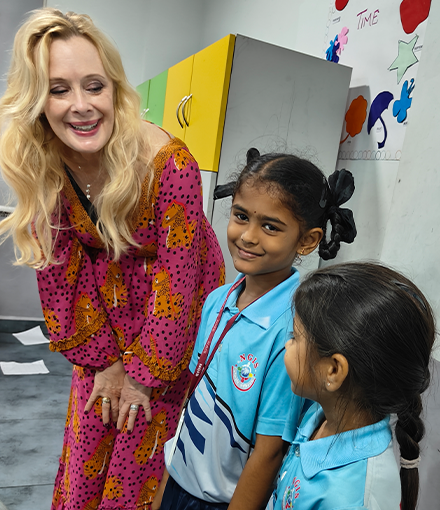 Dr. Kiki Caruson interacting with two students from the Next Gen International School in India.