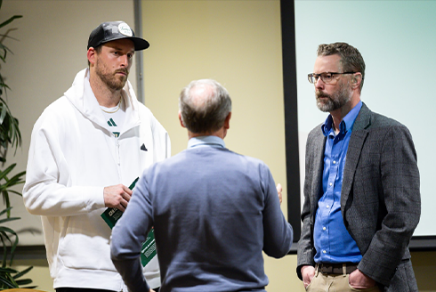 Three gentlemen - Andrew Stokes, USF Football punter; Olivier Debure, Associate Director OIS, Keith Miller, Vice-President Influxer - discussing naming, image, and likeness question the 2024 BOOST NIL Symposium