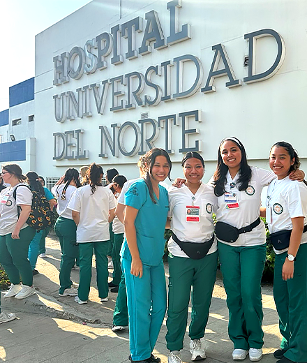four nursing students standing outside the hospital universidad del norte