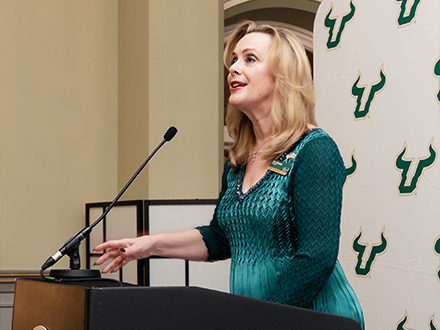 Dr. Caruson speaks at podium