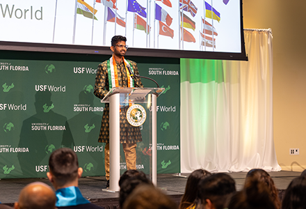 USF graduating student speaking at the podium