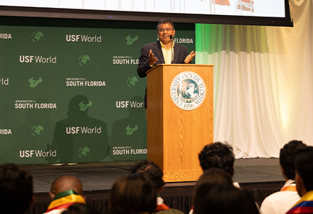USF provost speaking at the podium on stage