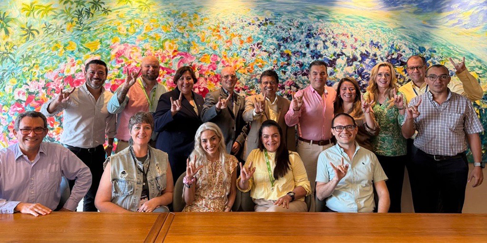 Group of people smiling with a colorful art background