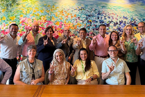 Group of people smiling with a colorful art background