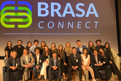 group of students under a screen that says