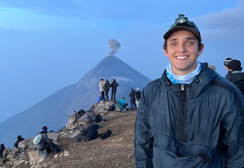 Jackson Anderson standing before a life volcano