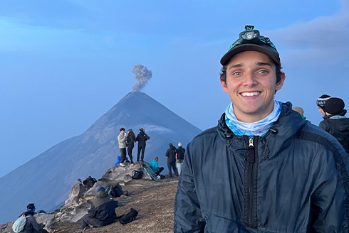 Jackson Anderson standing before a life volcano