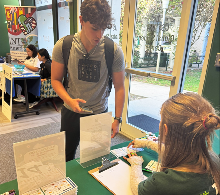 Students signing in at a booth