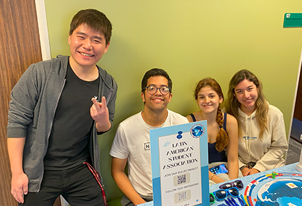 a group of students at a table, smiling