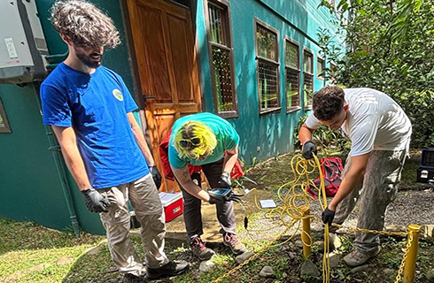 Jackson Anderson and Facundo Pereyra-Kluser collecting a water sample from a constructed wetland. (Photo by Nancy Romero-Daza)