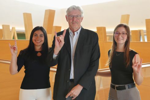 Alison Frate, Dr. Gregory Smogard, and Abigail Brake show their bull pride on the fifth floor of the Honors building, overlooking the atrium.