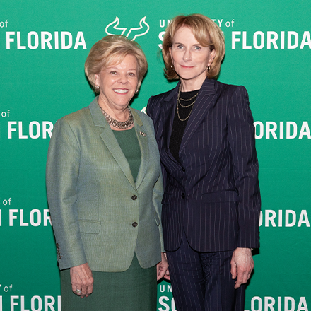 Sheppard and USF President Law standing together with USF Green background