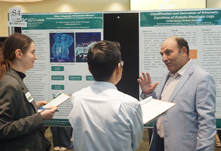 A scholar presenting their project to two people holding clipboards