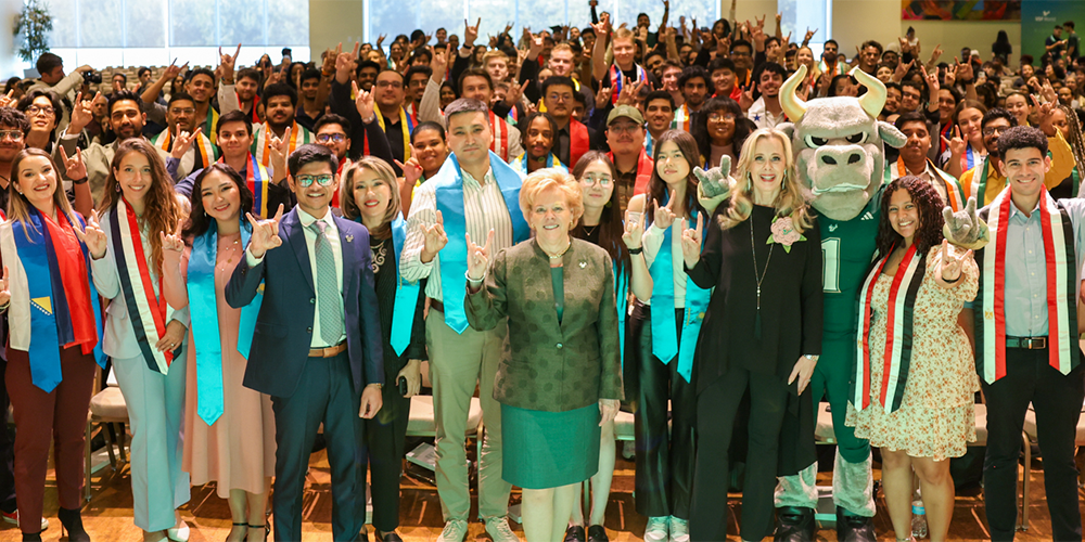 group of international students with Rocky the Bull, outgoing USF President Rhea Law, Student Body president, and Vice President of USF World