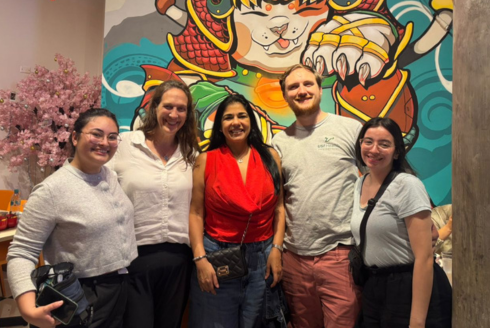 Group of students in front of a mural