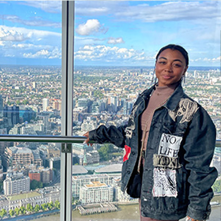 Student standing in front of landscape
