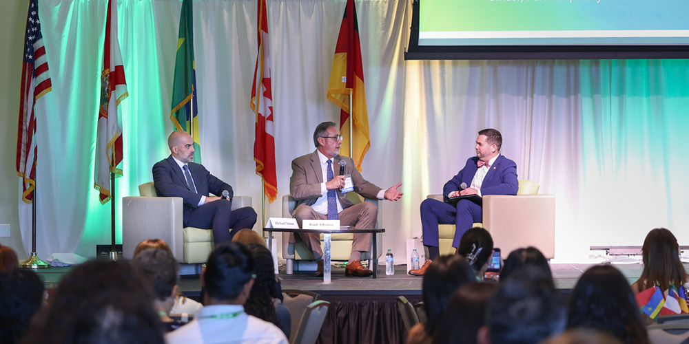 Group of people discussing in chairs before a crowd of people
