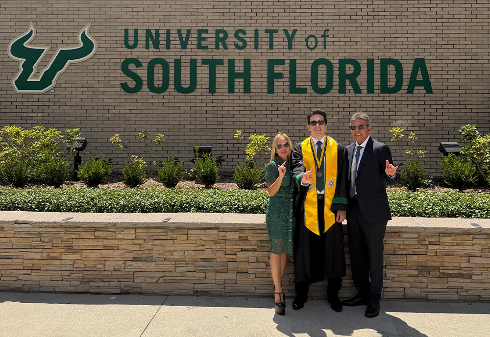 Cabello and his family in front of the USF brick sign