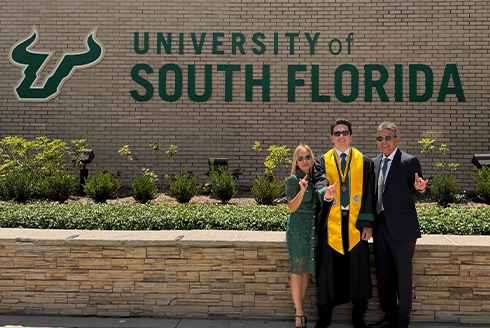 Cabello and his family in front of the USF brick sign