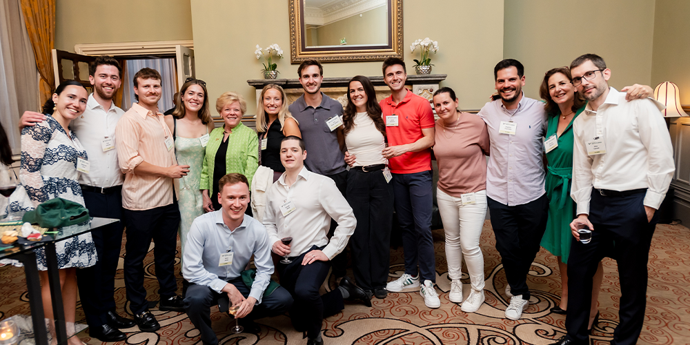 Carratt standing with a group people smiling