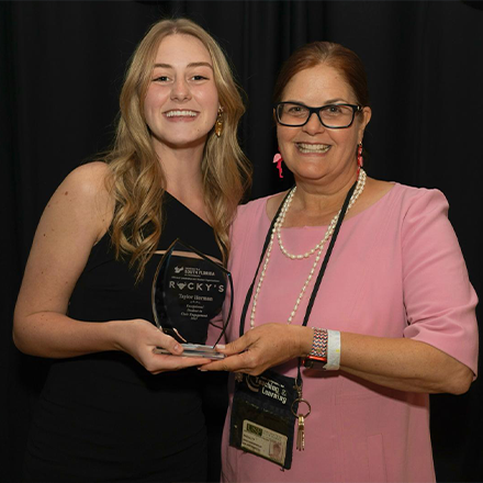 herman holding an award with another person smiling